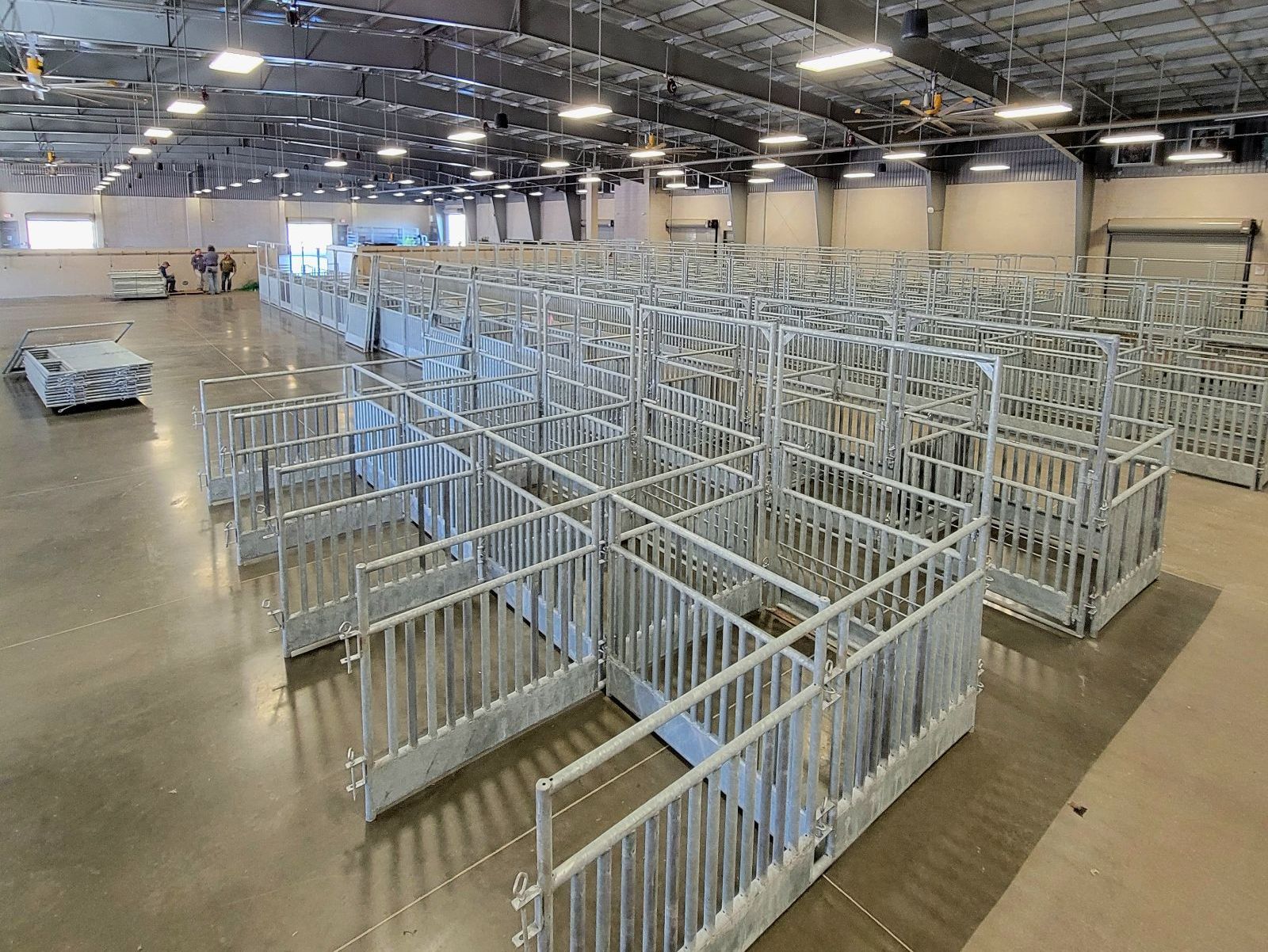 A large warehouse filled with lots of metal fences.