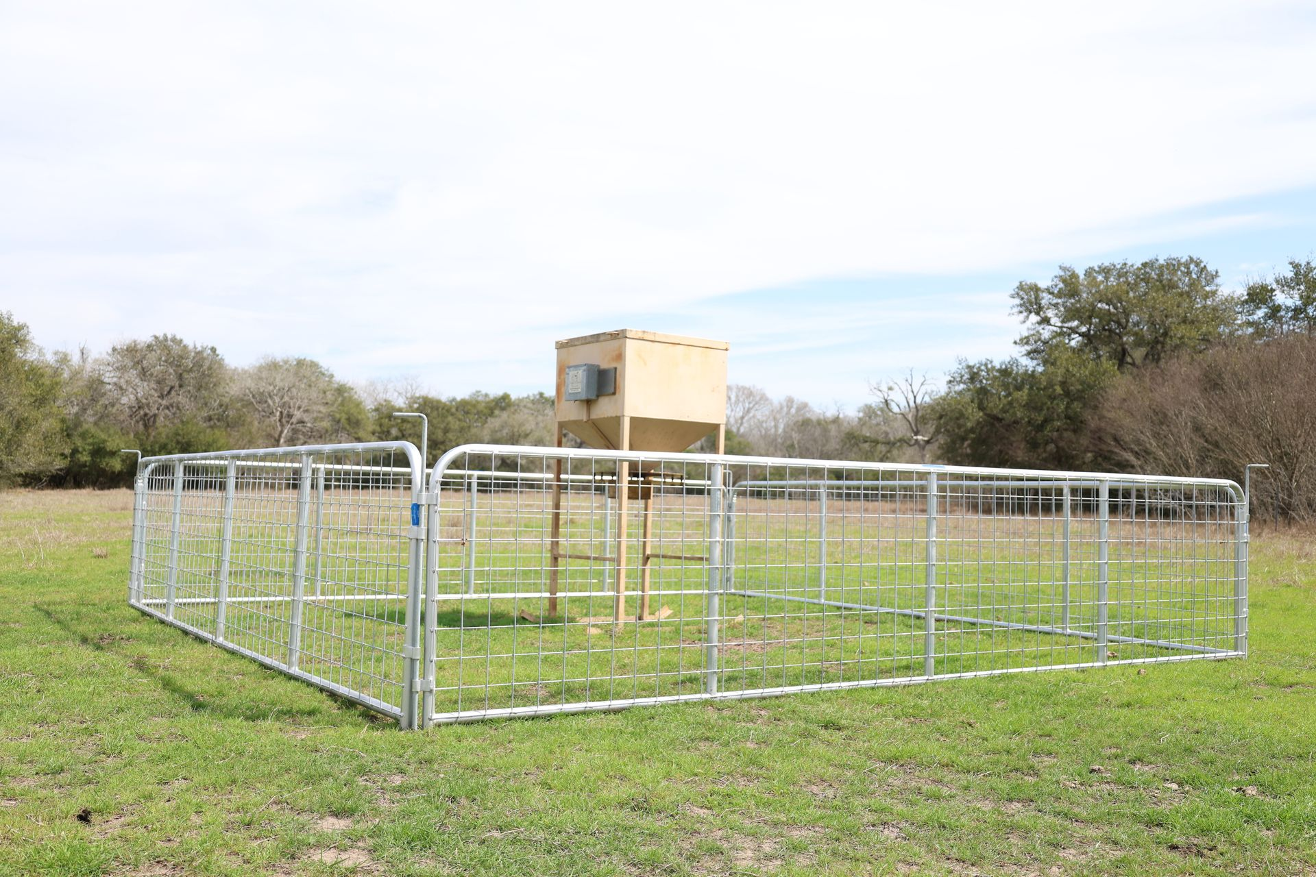 A metal fence is sitting on top of a gravel road.