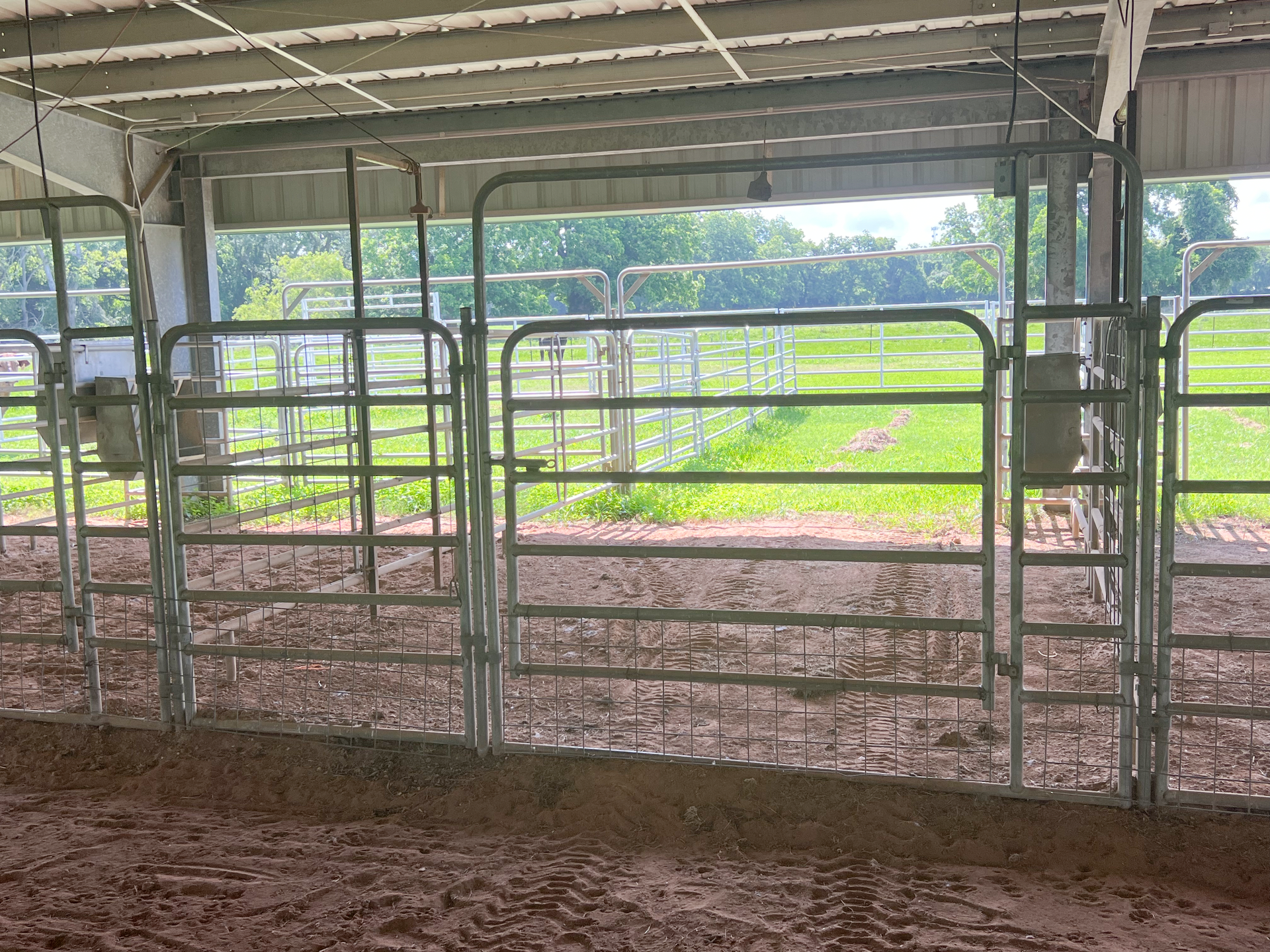 A fenced in area with a field in the background