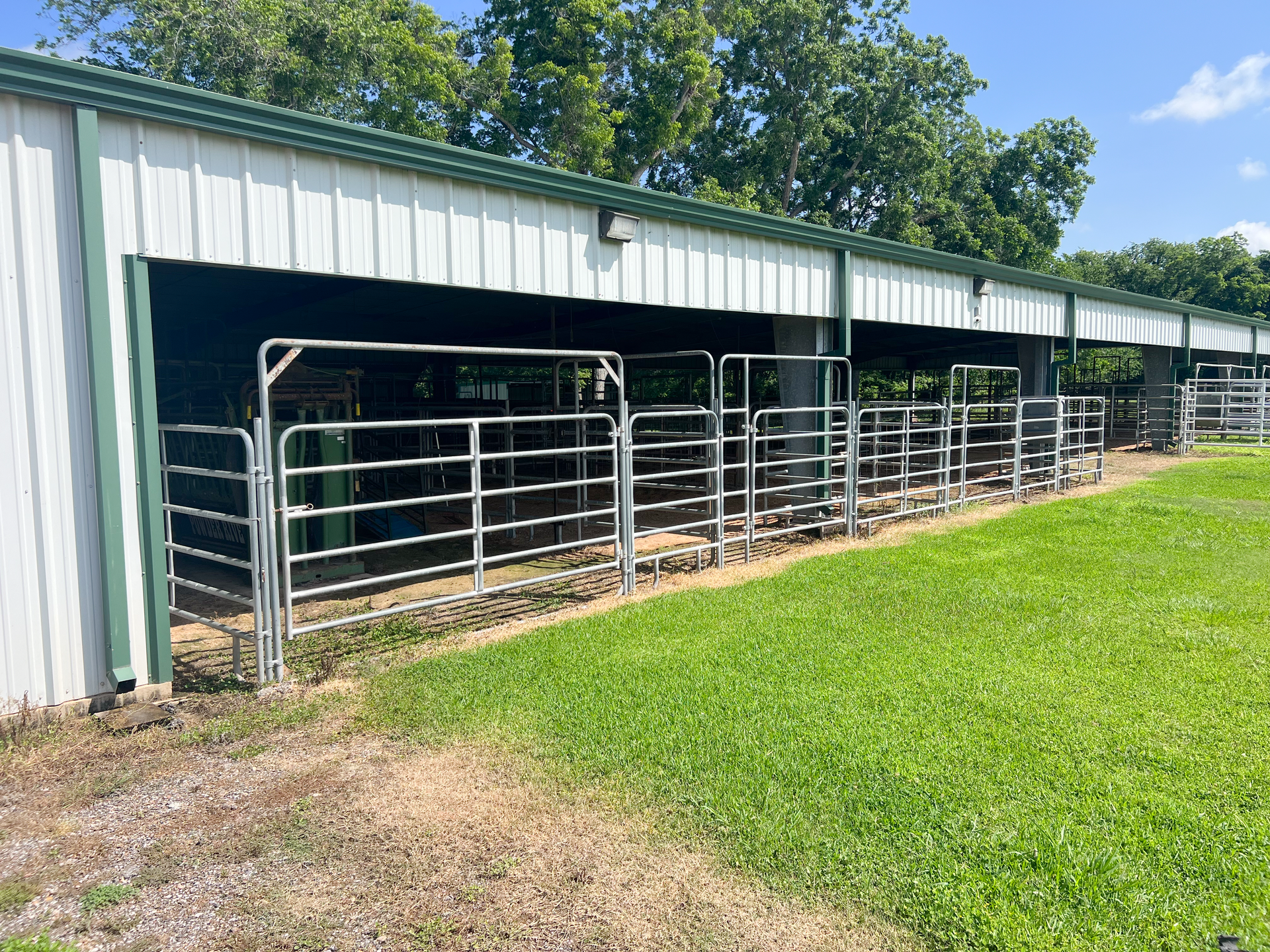 A row of fences surrounding a building in a field.
