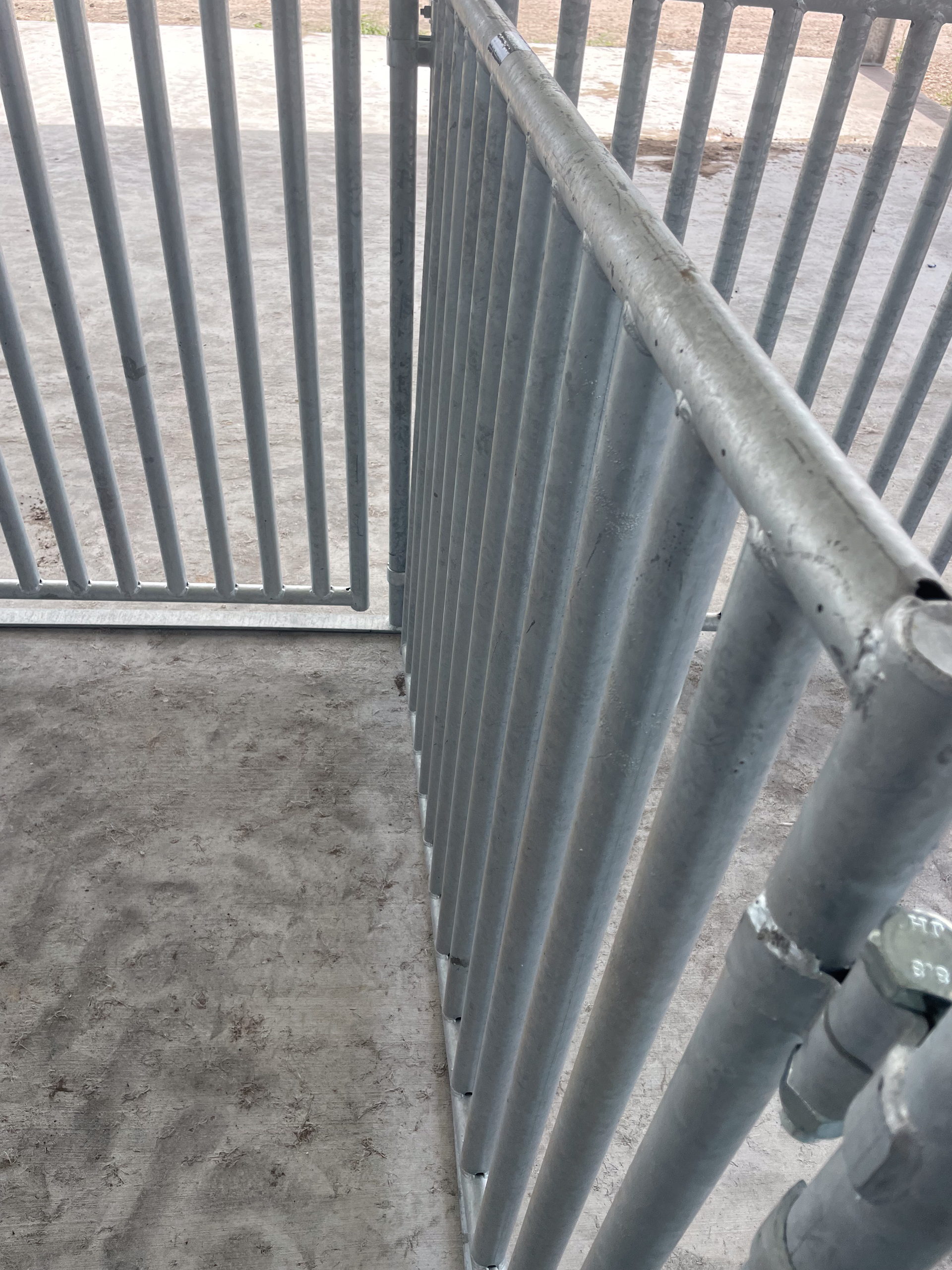 A close up of a metal fence with a hole in it