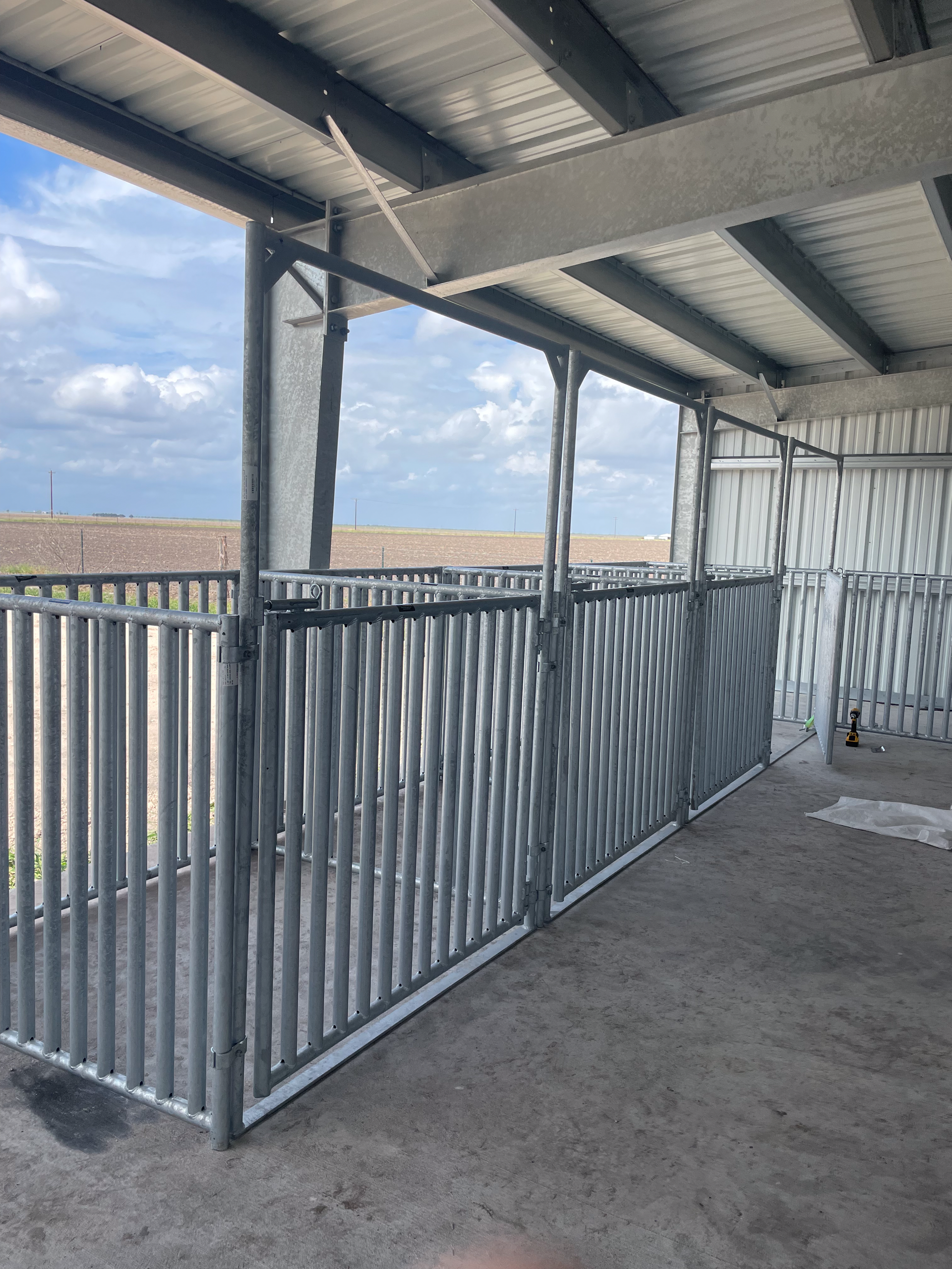 A building with a fence and a view of a field.