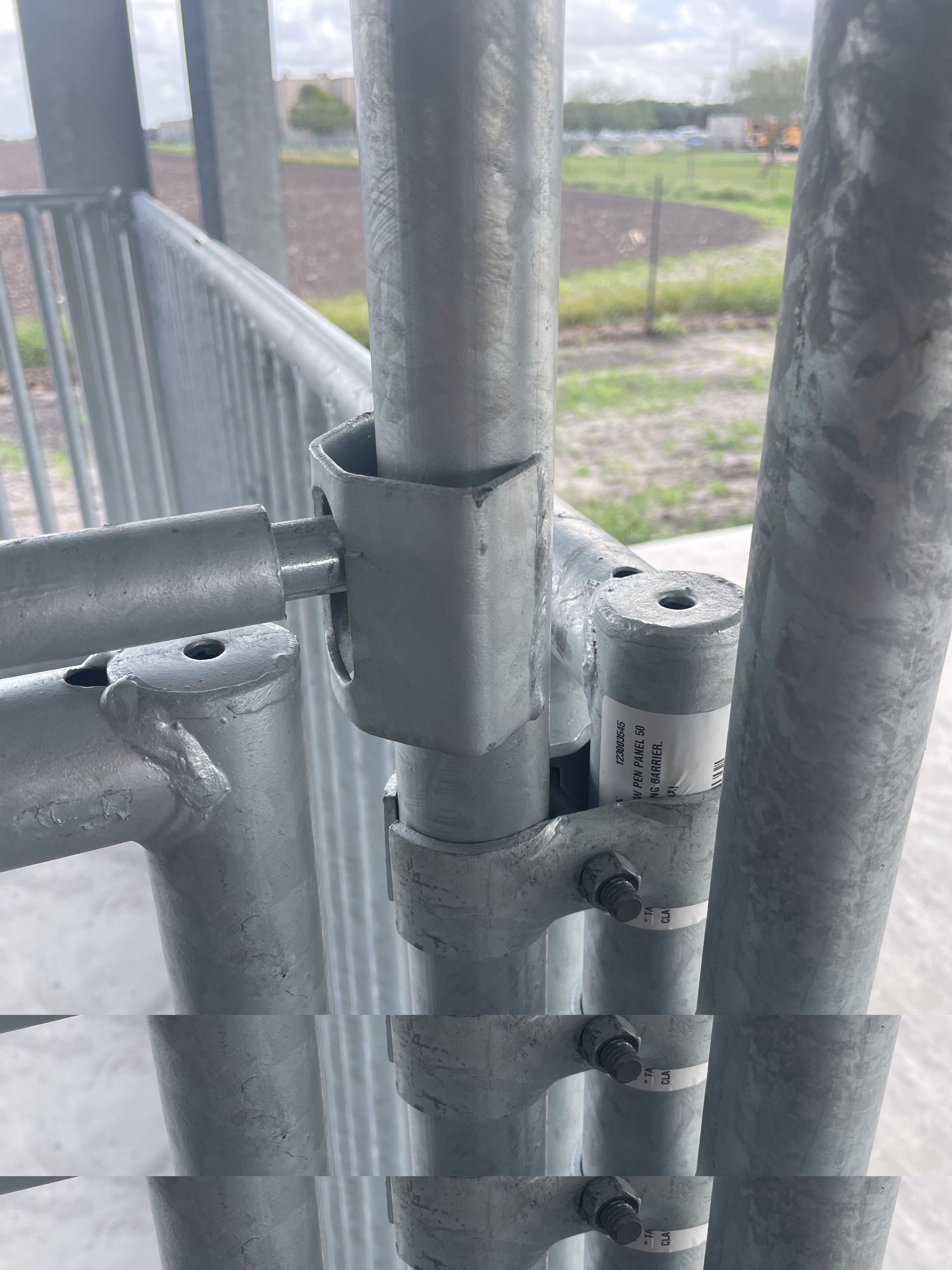 A close up of a metal structure with a fence in the background