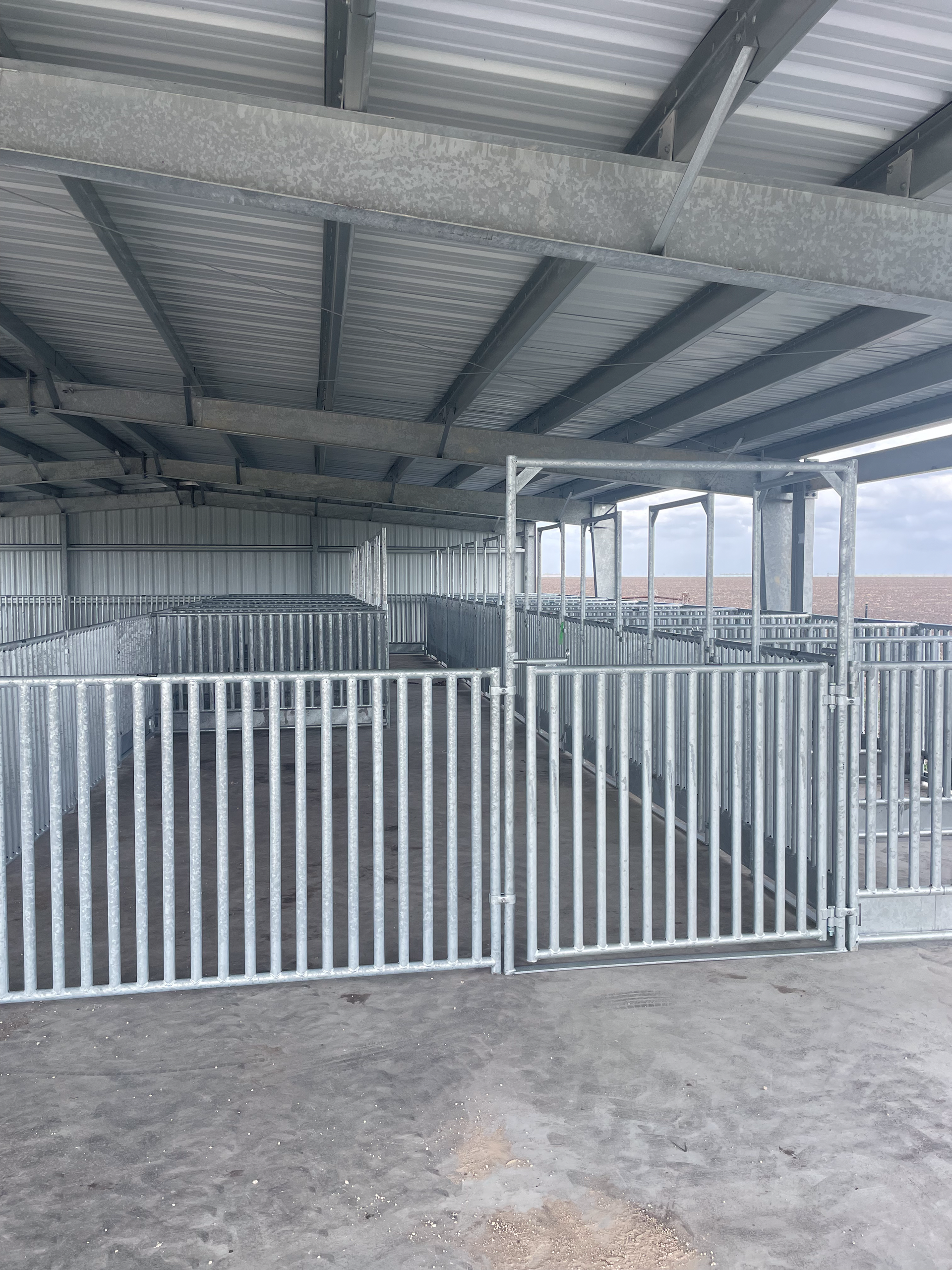 A white fence surrounds a building with a roof