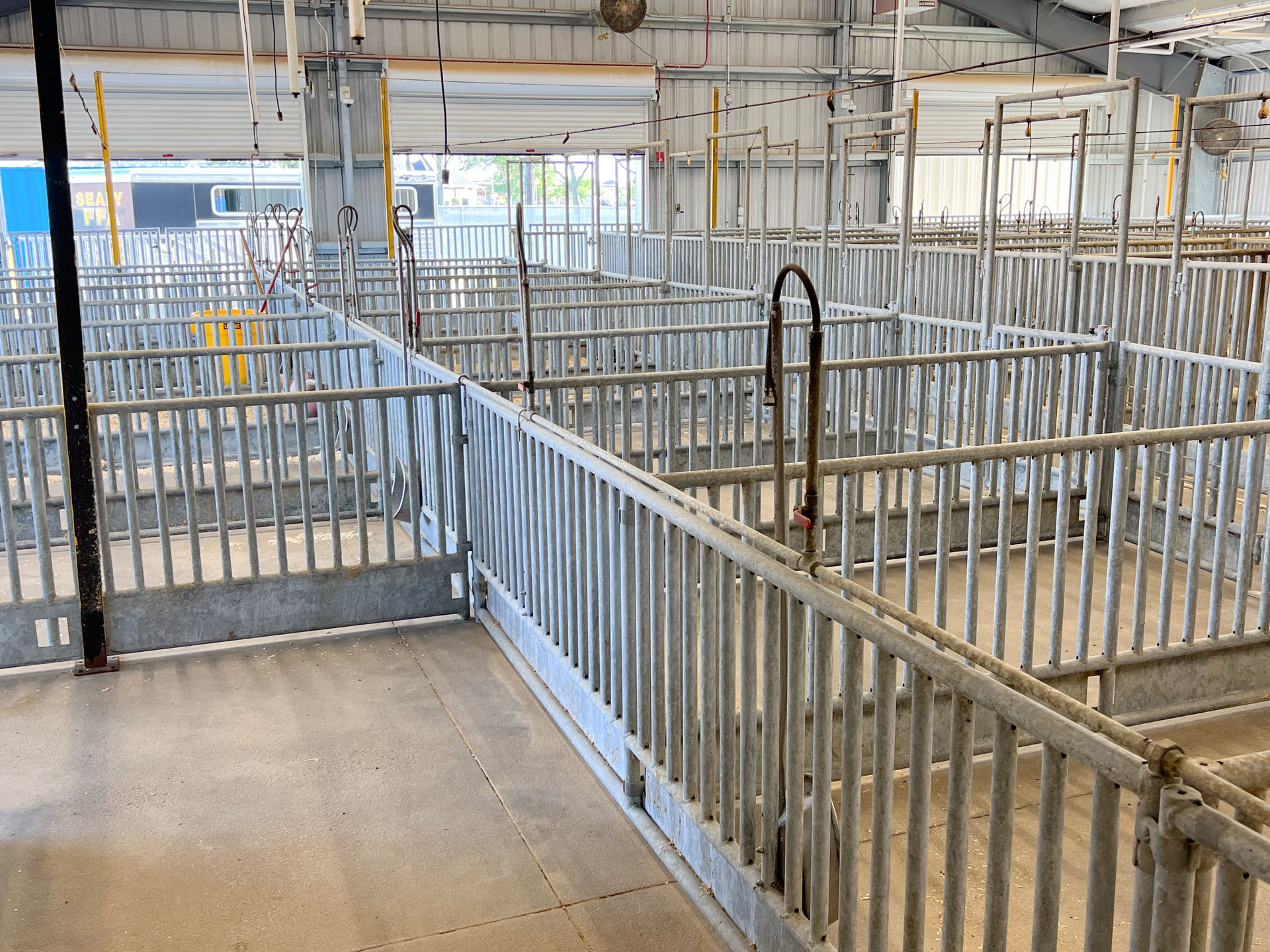 A large empty building with a lot of metal fences