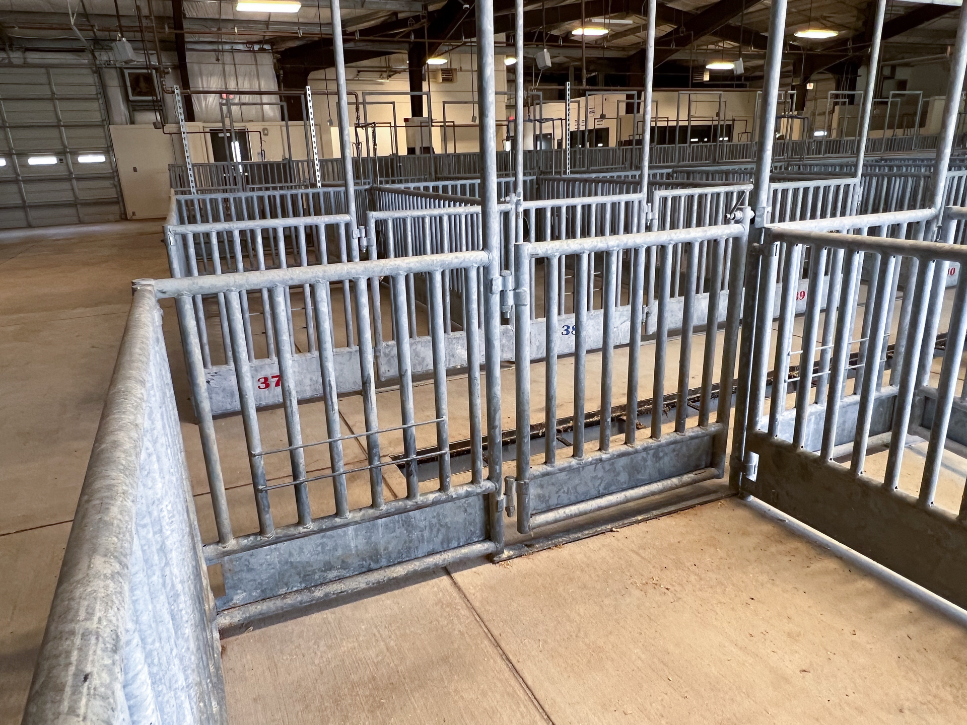 A row of fences in a warehouse with a sign that says ' a2 ' on it