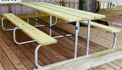 A wooden picnic table on a wooden deck