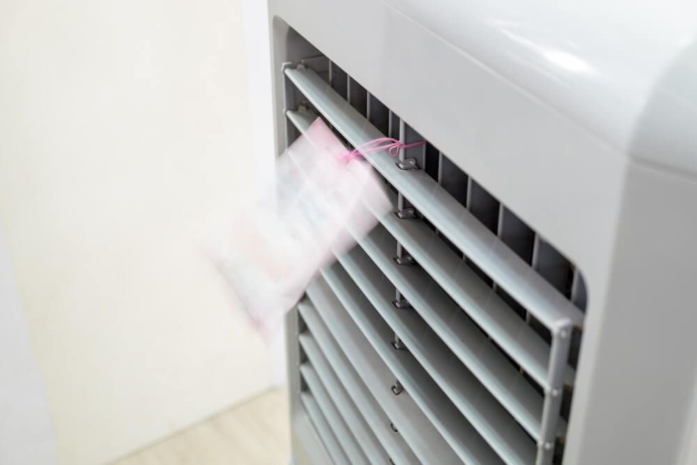 A Close up Of a White Air Conditioner with A Pink Sticker on It — Care Mechanical Services in Wagga Wagga, NSW