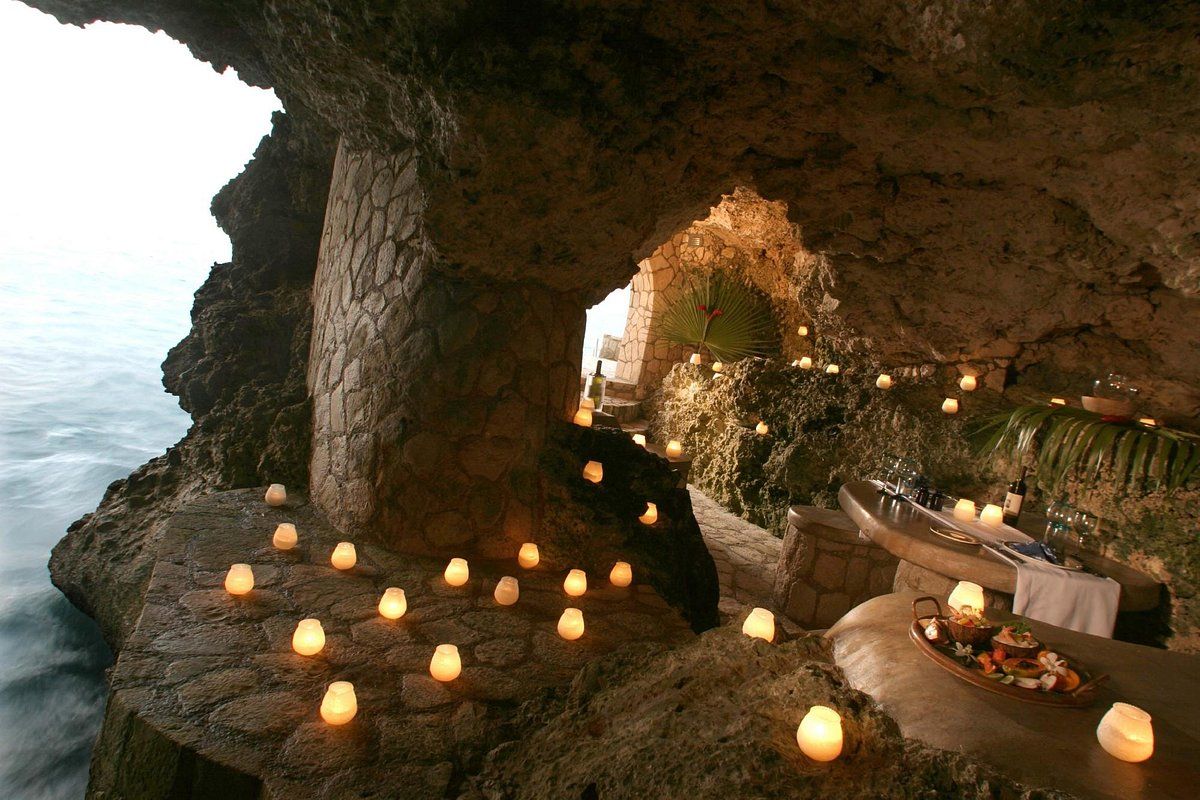 A cave filled with candles and a table
