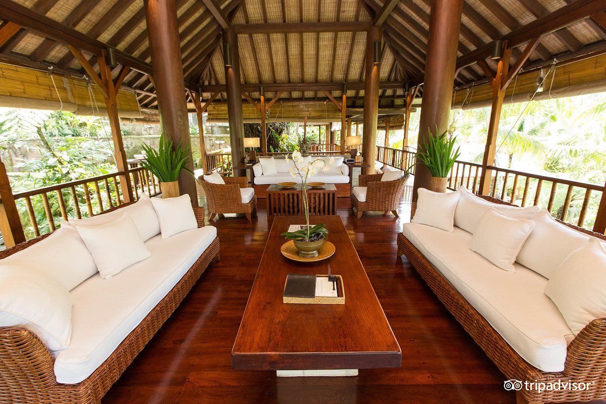 A living room with wicker furniture and a wooden table