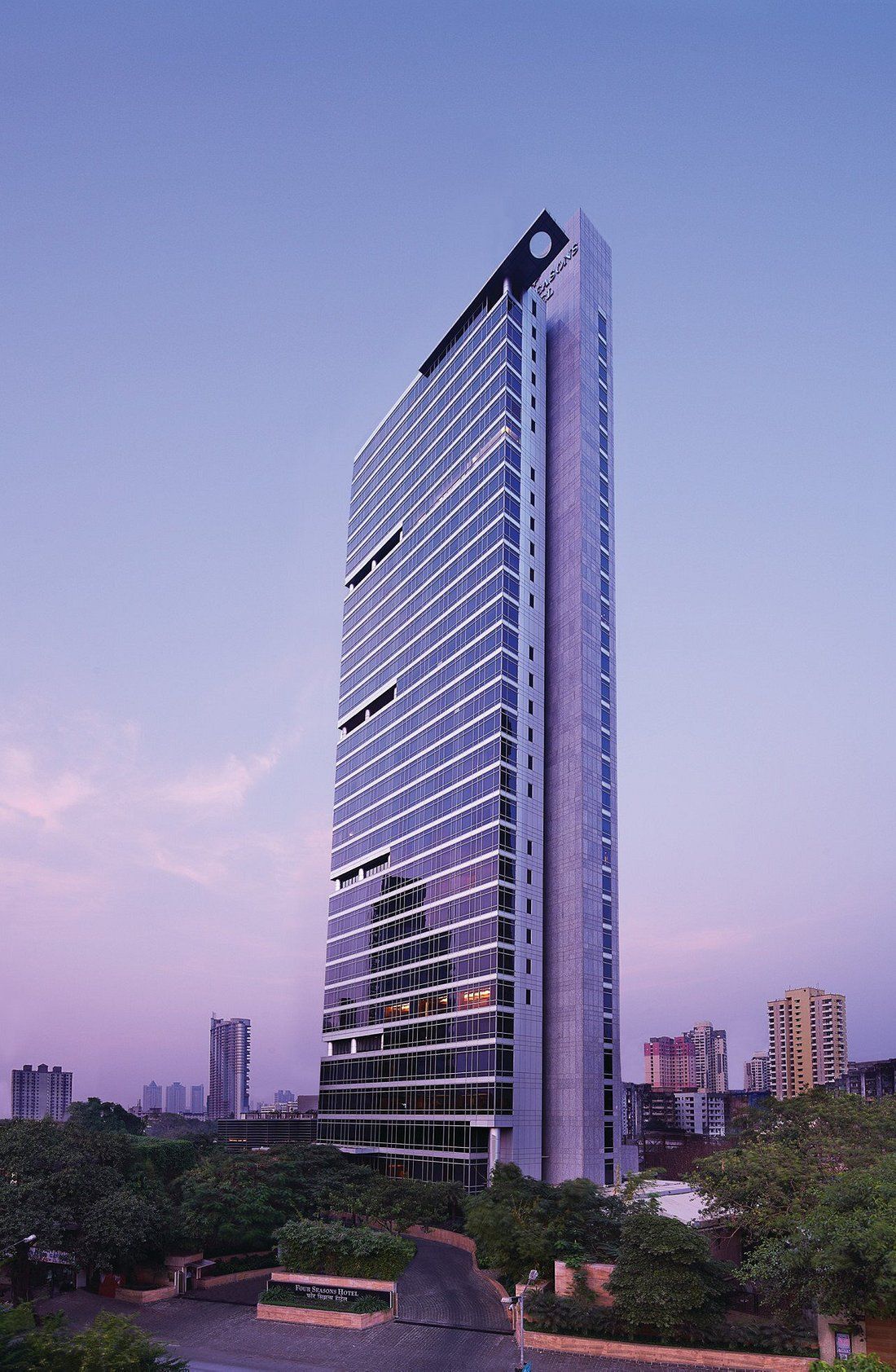 A tall building with a purple sky in the background.