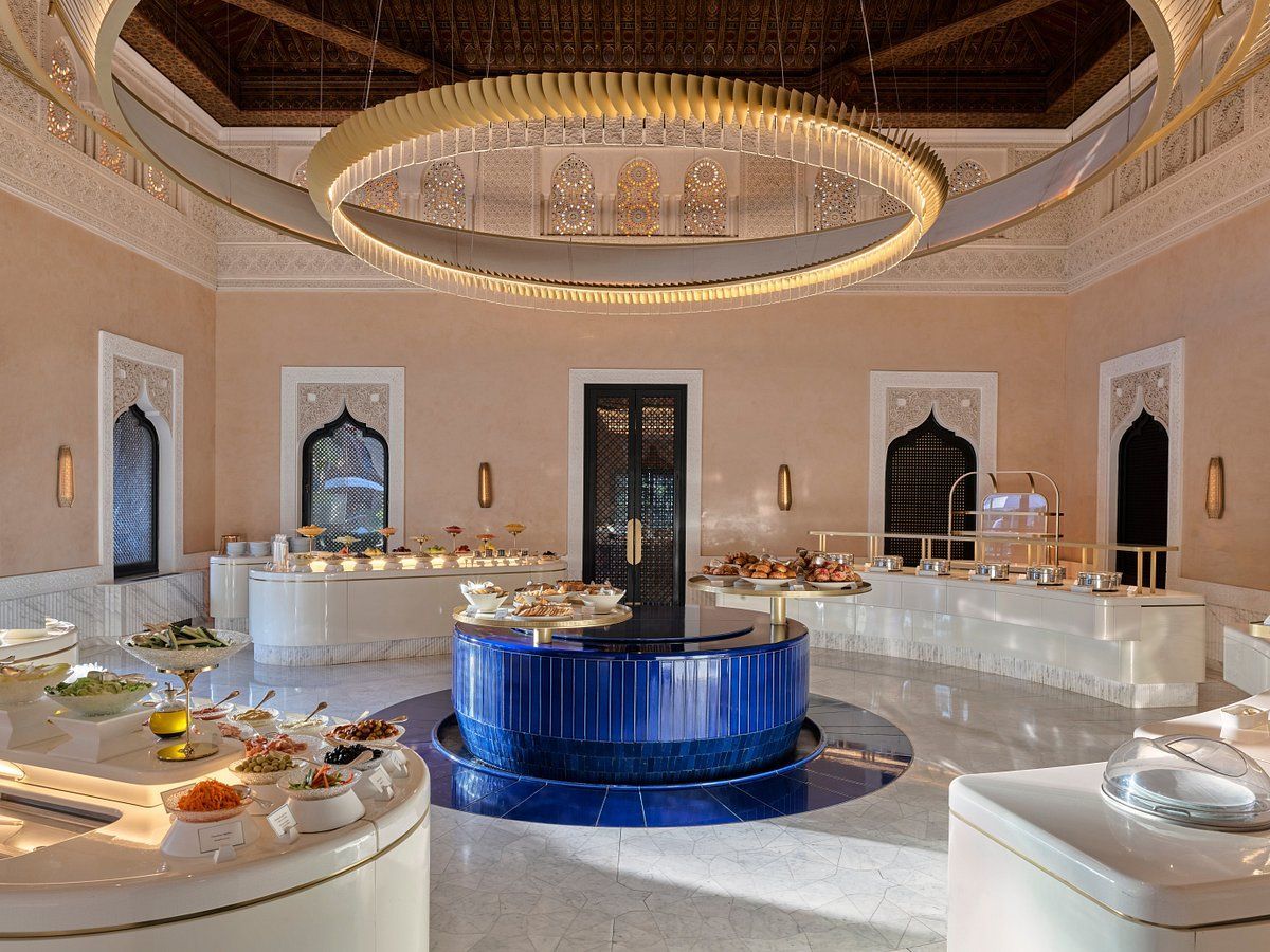 A large room filled with lots of food and a large chandelier.