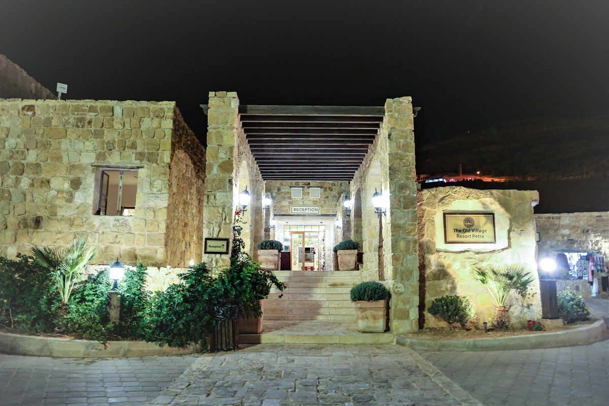 A large stone building with stairs leading up to it at night.