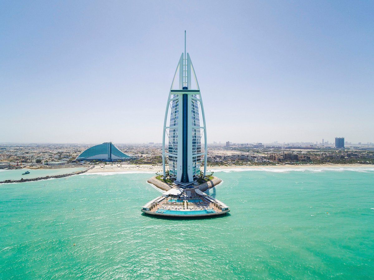 An aerial view of a very tall building in the middle of the ocean.