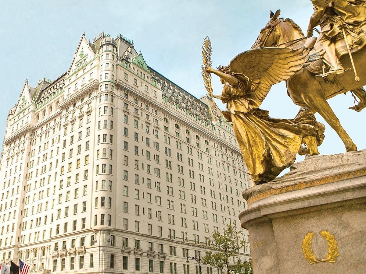 A large building with a statue in front of it