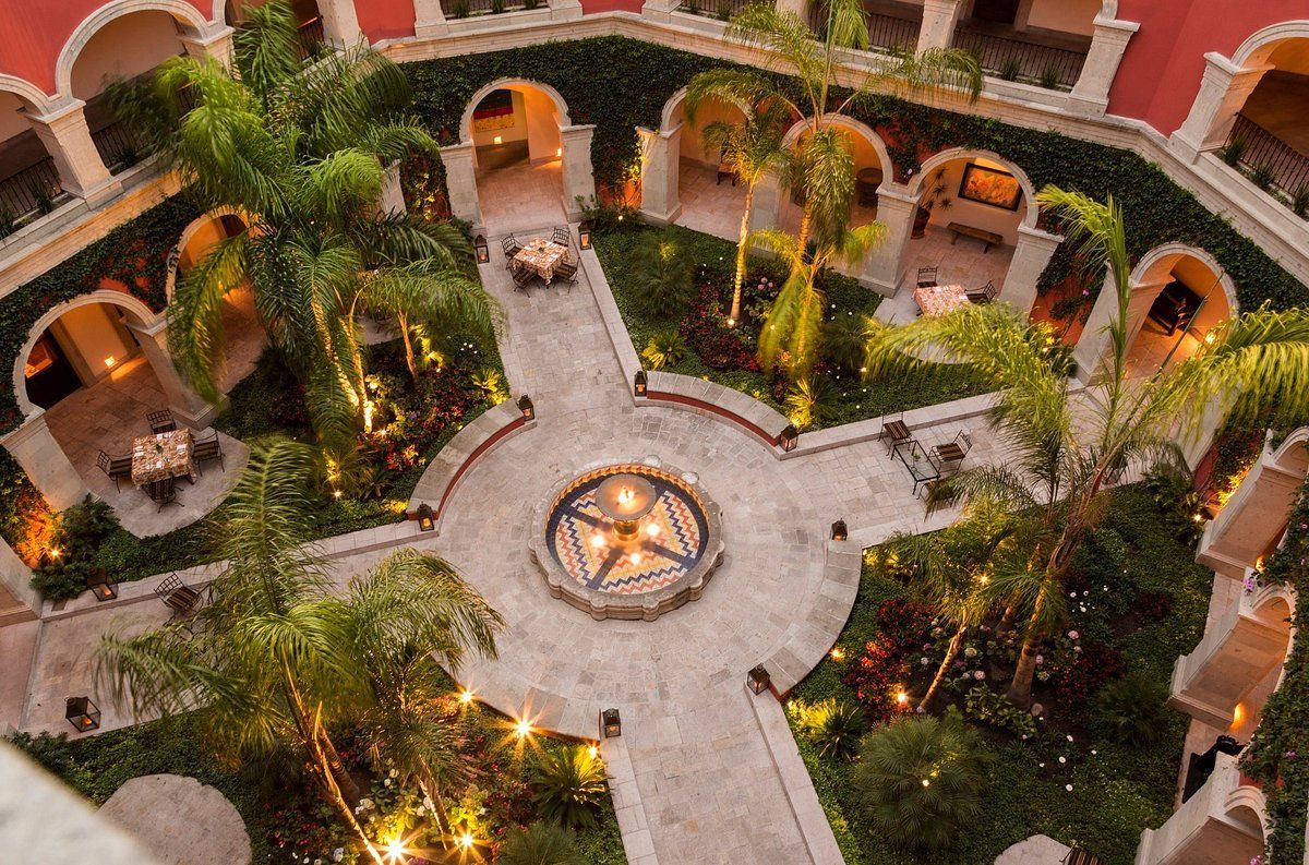 An aerial view of a courtyard filled with trees and tables.