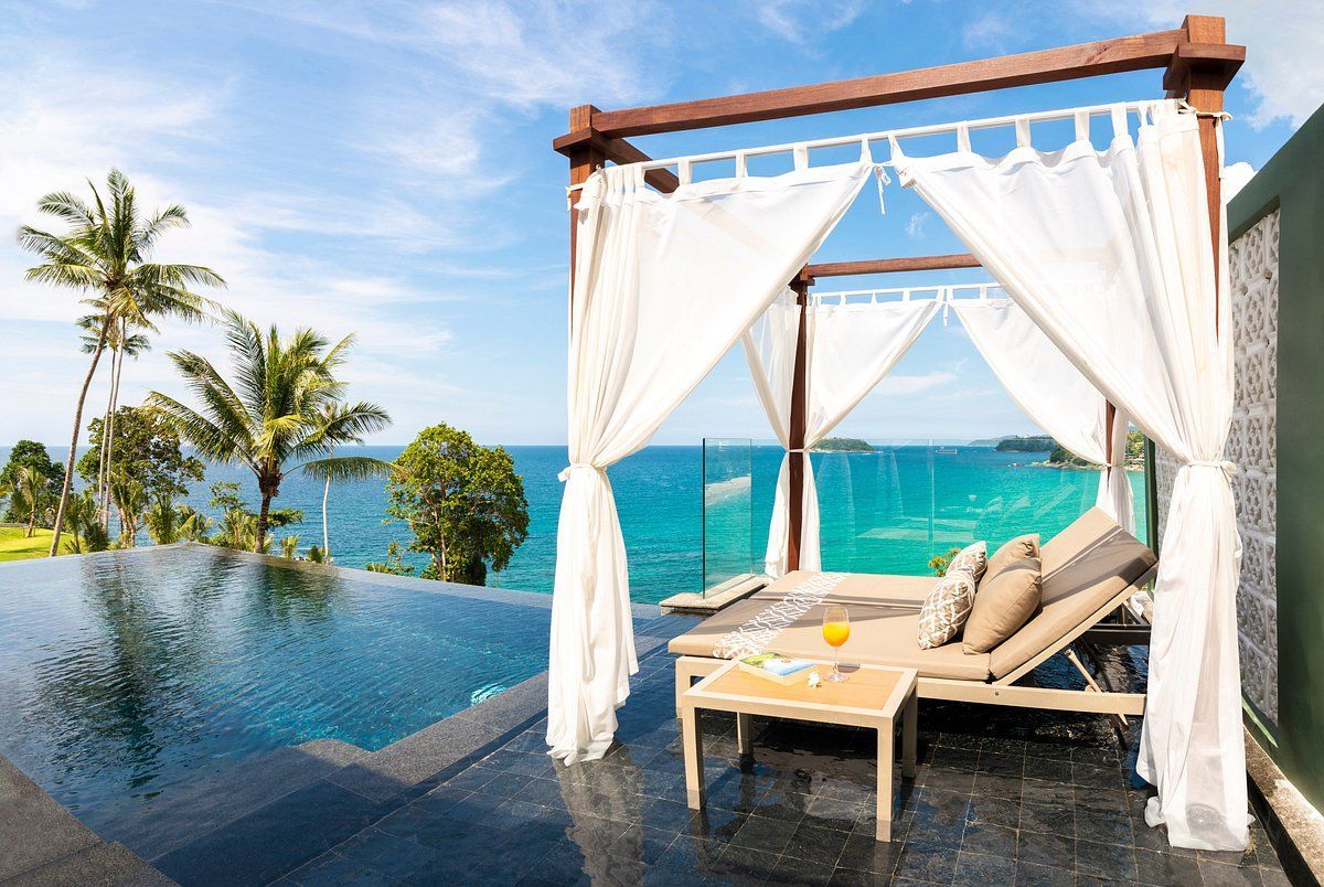 A canopy overlooking a swimming pool with a view of the ocean.