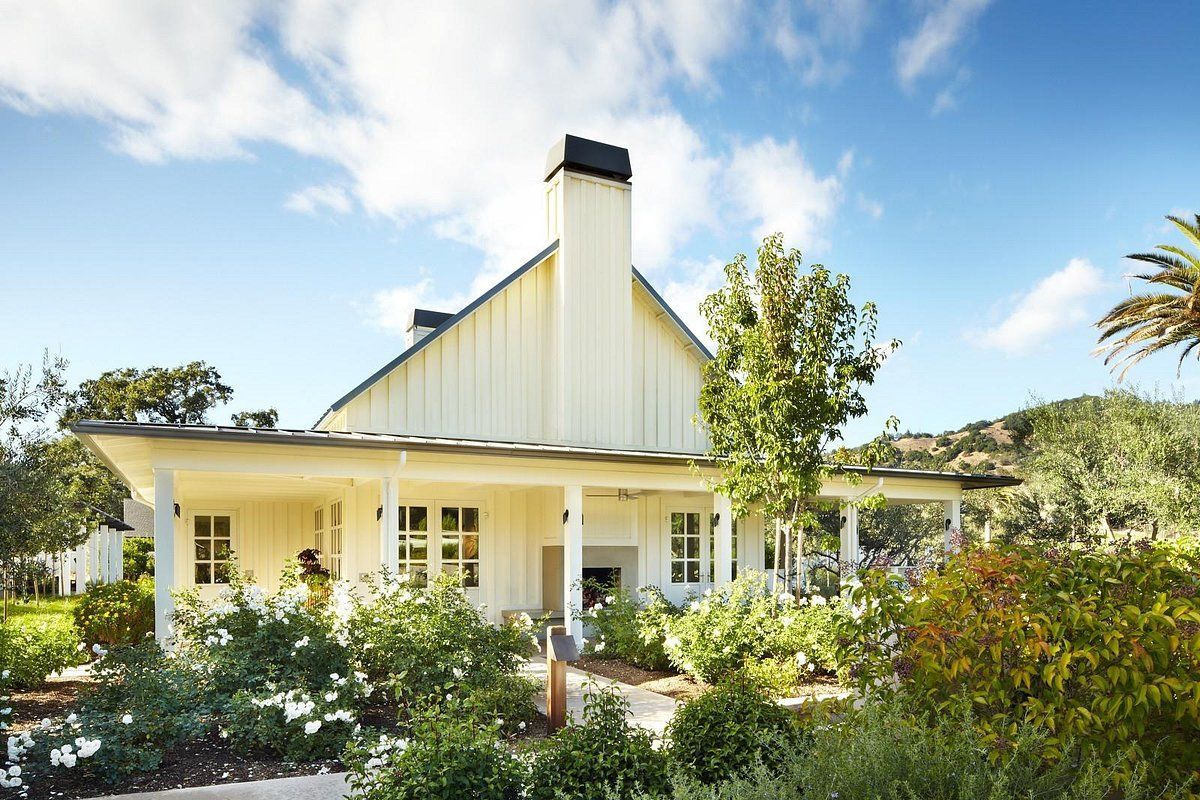 A large white house with a porch and a chimney