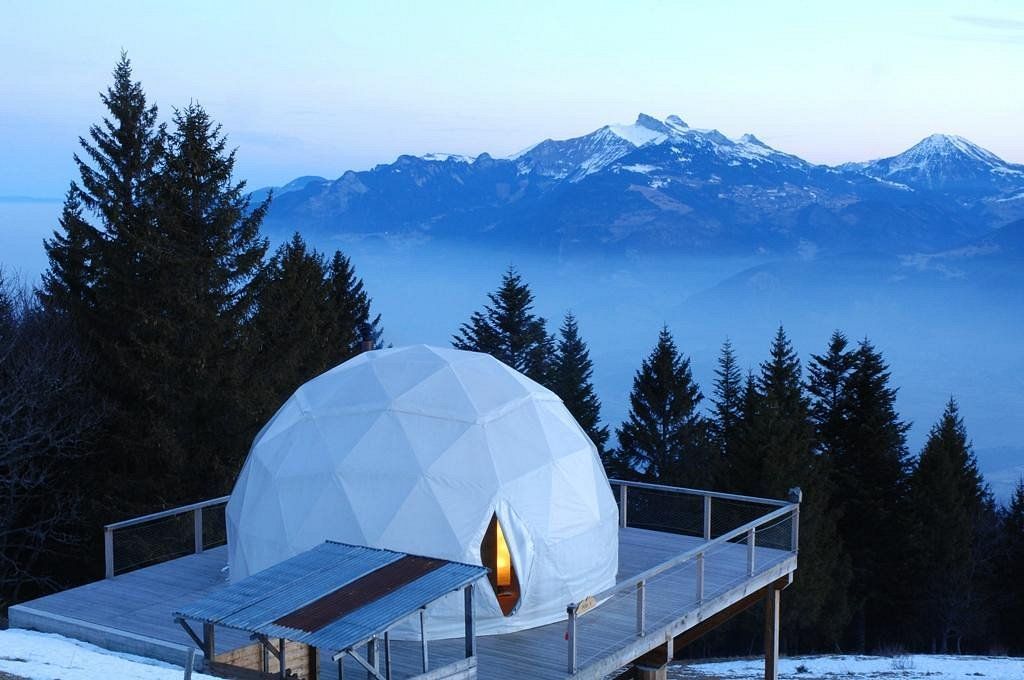 A dome on a deck with mountains in the background