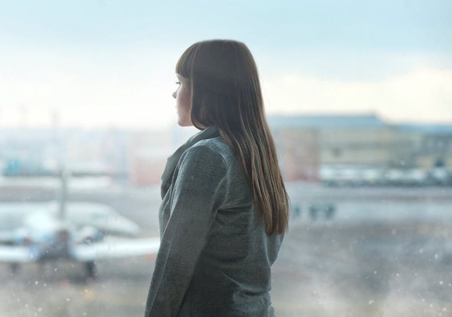 A doctor is talking to an elderly woman in a wheelchair.