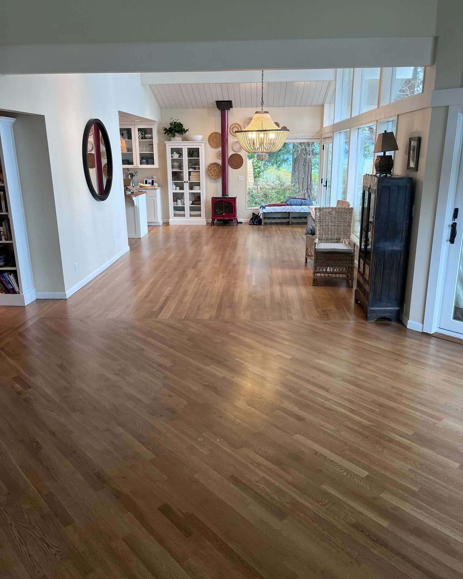 A living room with hardwood floors and a fireplace.