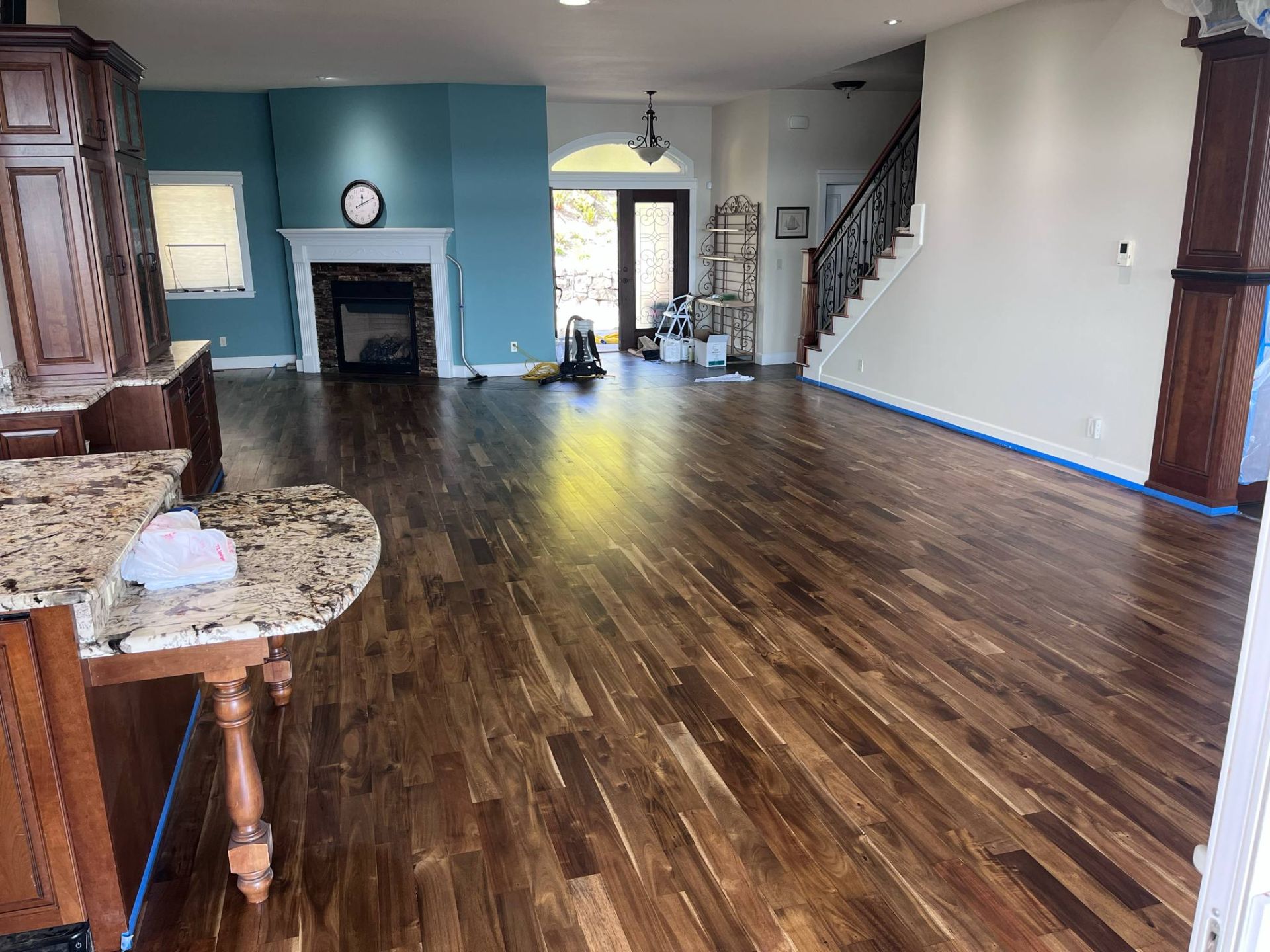 A living room with hardwood floors and a fireplace.