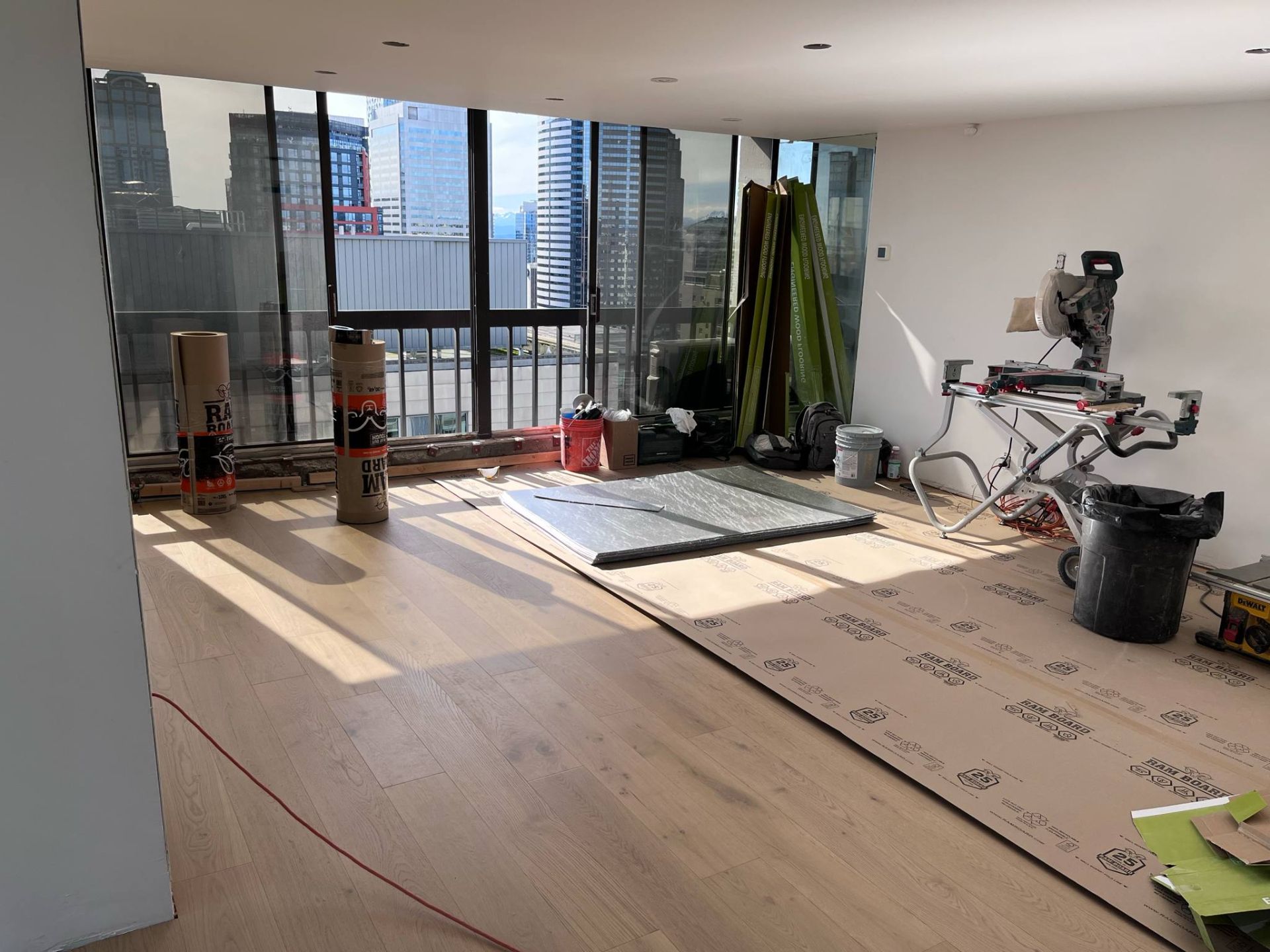 A large room with a lot of windows and a wooden floor.