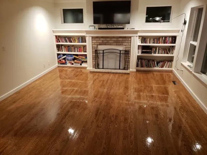 A living room with hardwood floors and a fireplace.