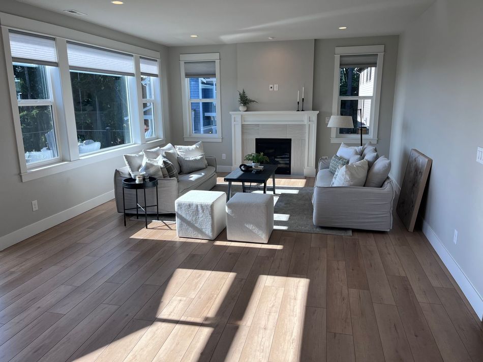 A room with a lot of windows and a wooden floor.