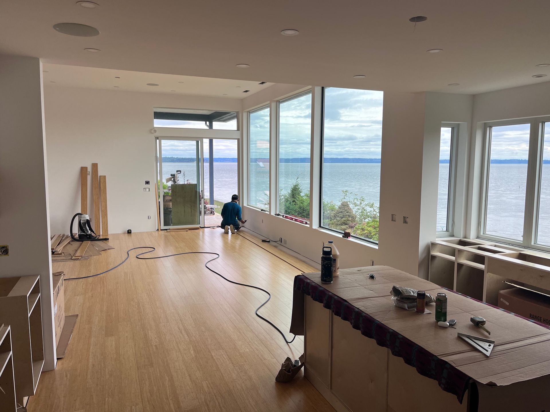 A large room with a lot of windows and a view of the ocean.