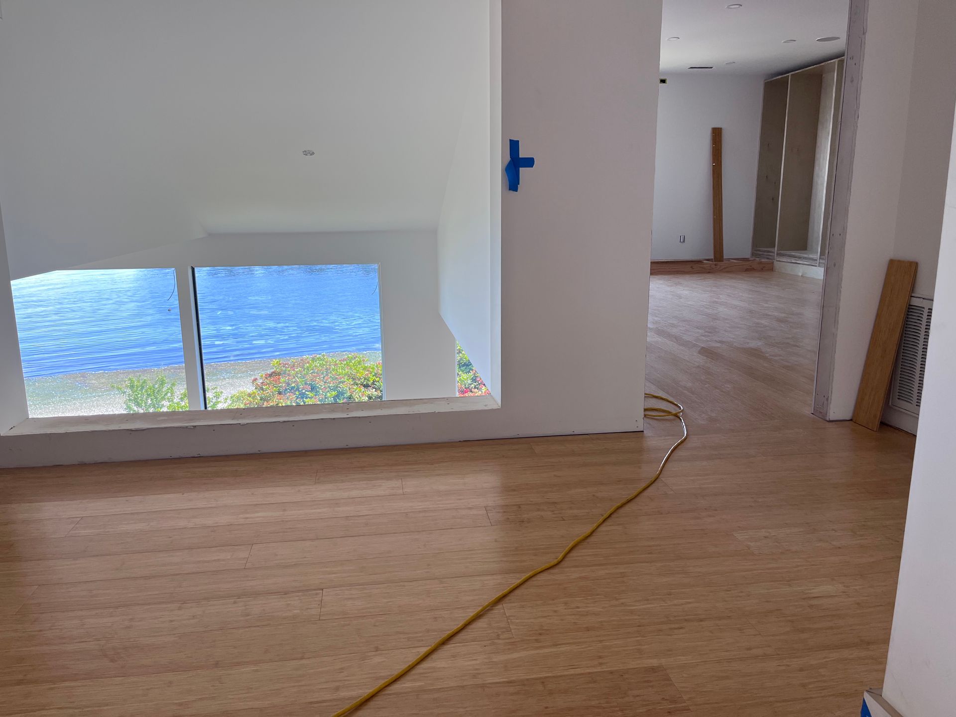 An empty room with a blue cross on the wall