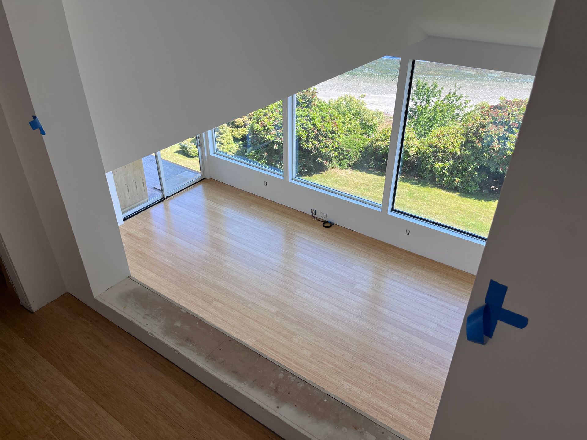 A room with a lot of windows and a wooden floor.