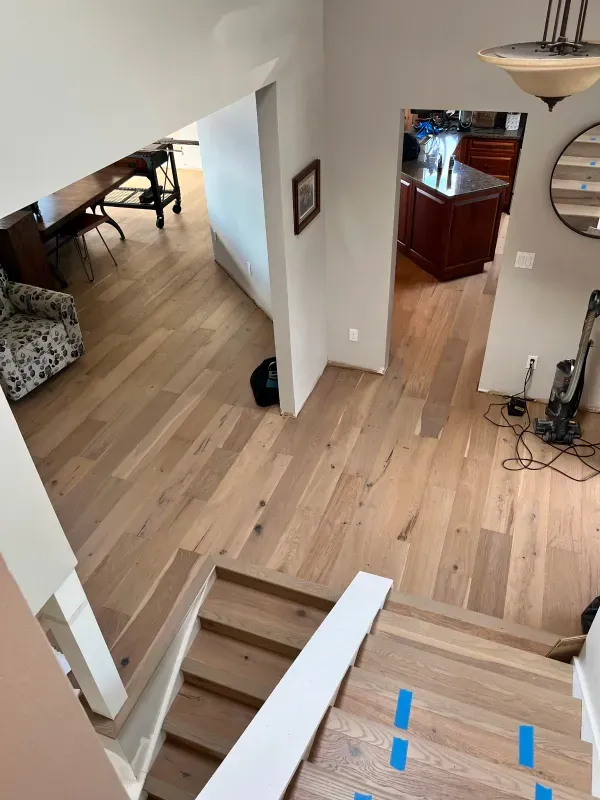 An aerial view of a house with hardwood floors and stairs.