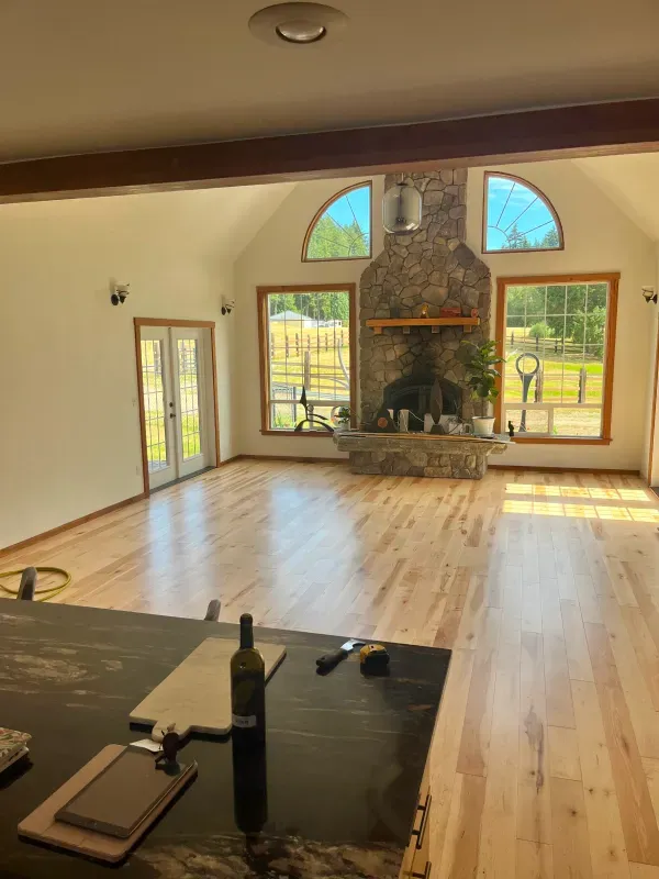 A living room with hardwood floors and a fireplace