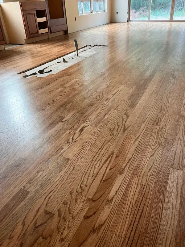 A living room with hardwood floors and a sliding glass door.