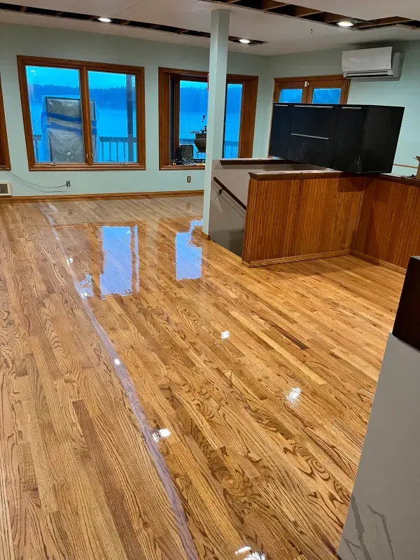 A kitchen with a lot of windows and a wooden floor