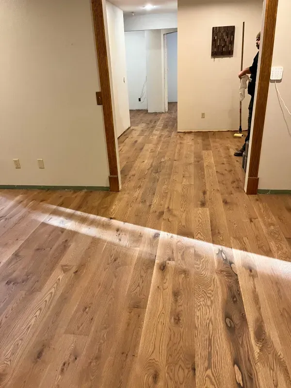 A room with hardwood floors and white walls.
