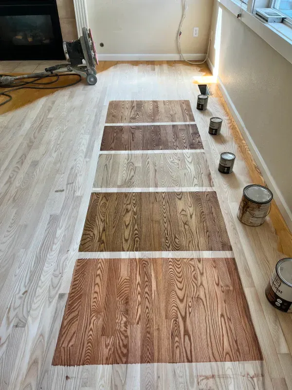 There are many different shades of wood on the floor.
