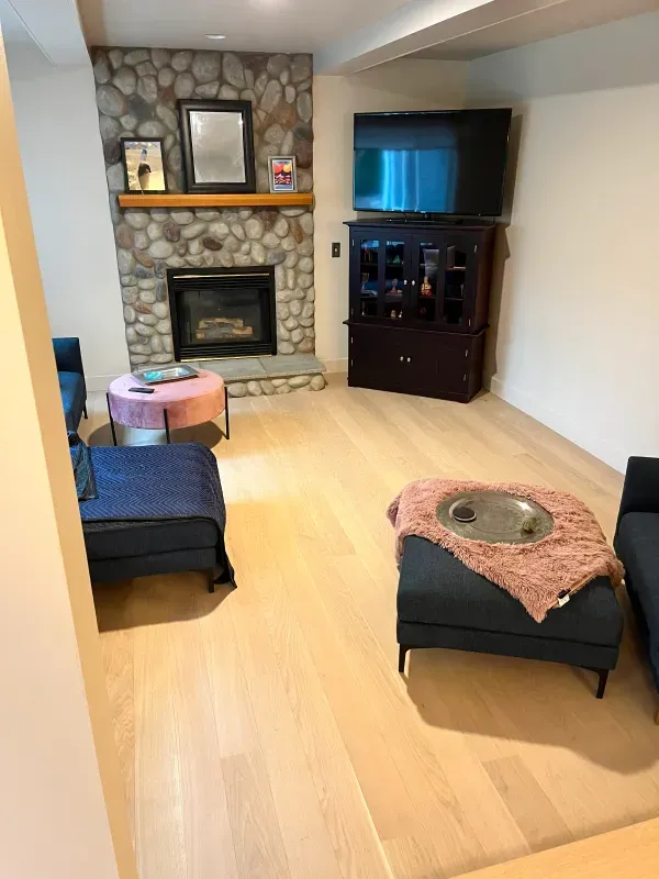 A living room with a fireplace and a flat screen tv