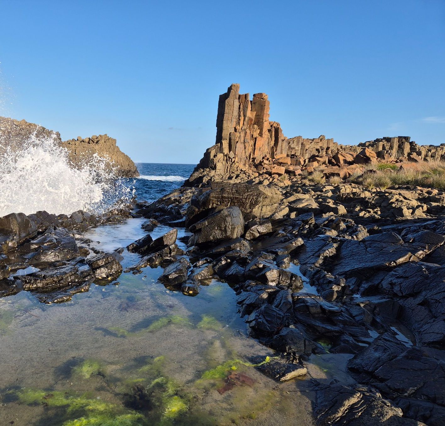 A rocky shoreline with waves crashing against the rocks