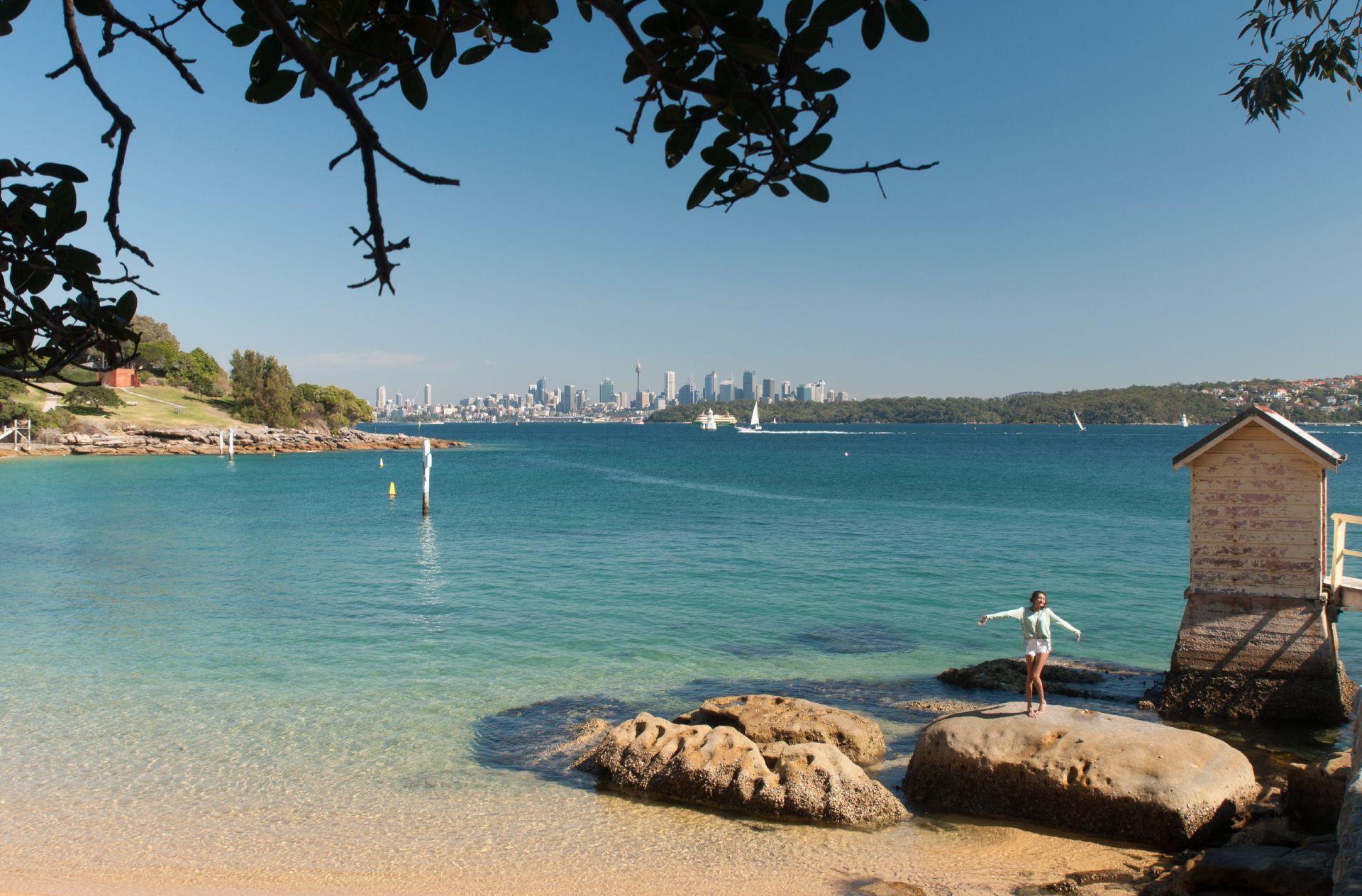 A person standing on a rock near a body of water
