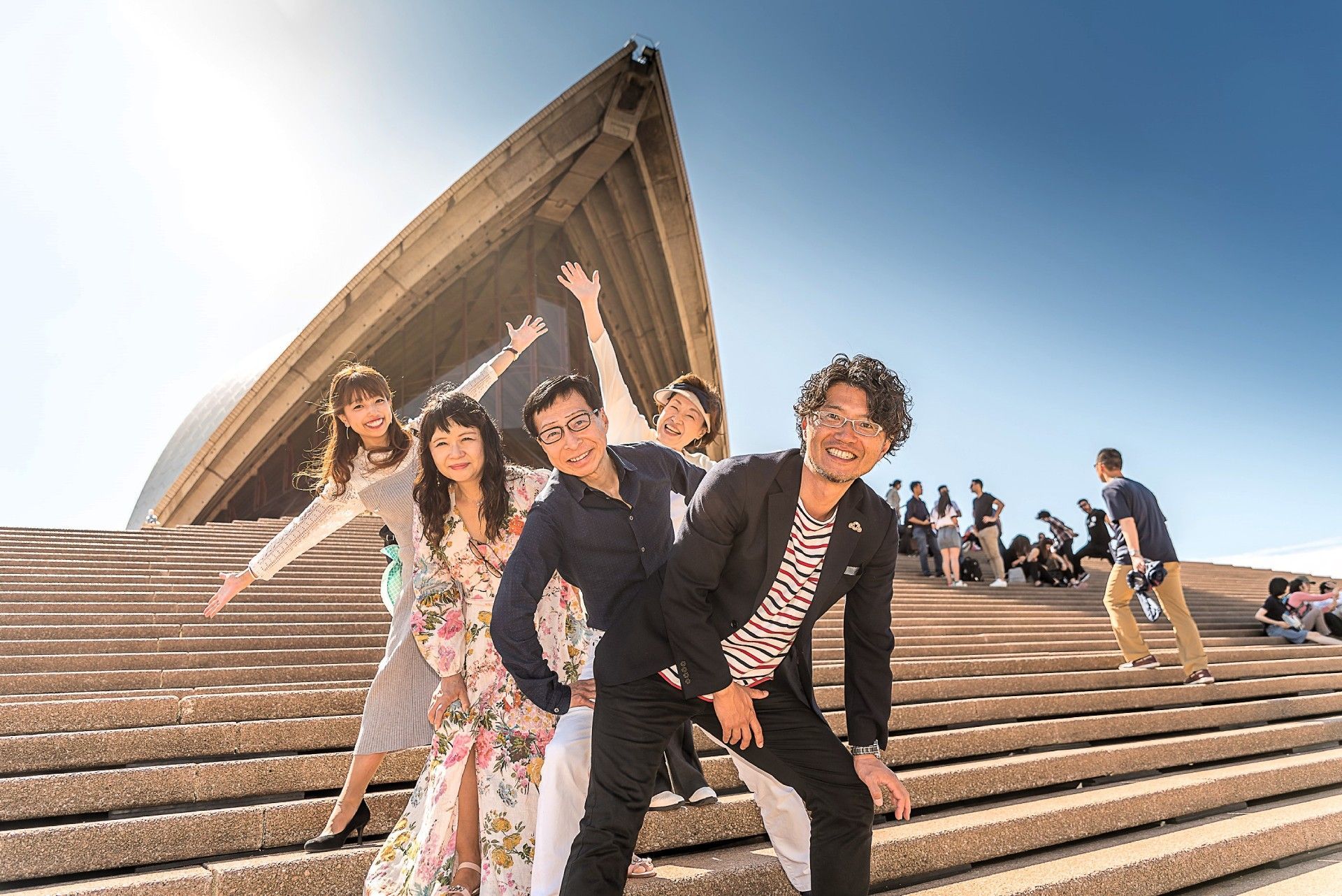 A group of people are posing for a picture on a set of stairs.