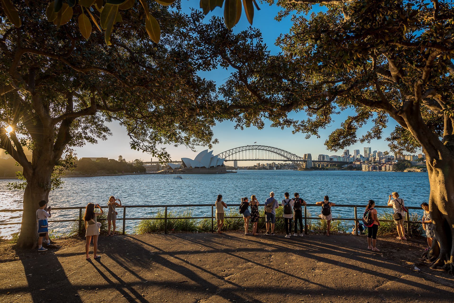 A group of people are standing near a body of water