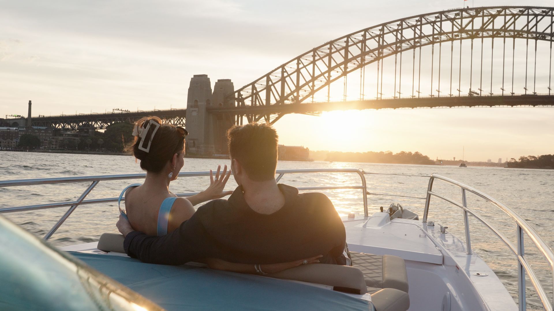 A group of people are standing on top of a cliff overlooking a valley.