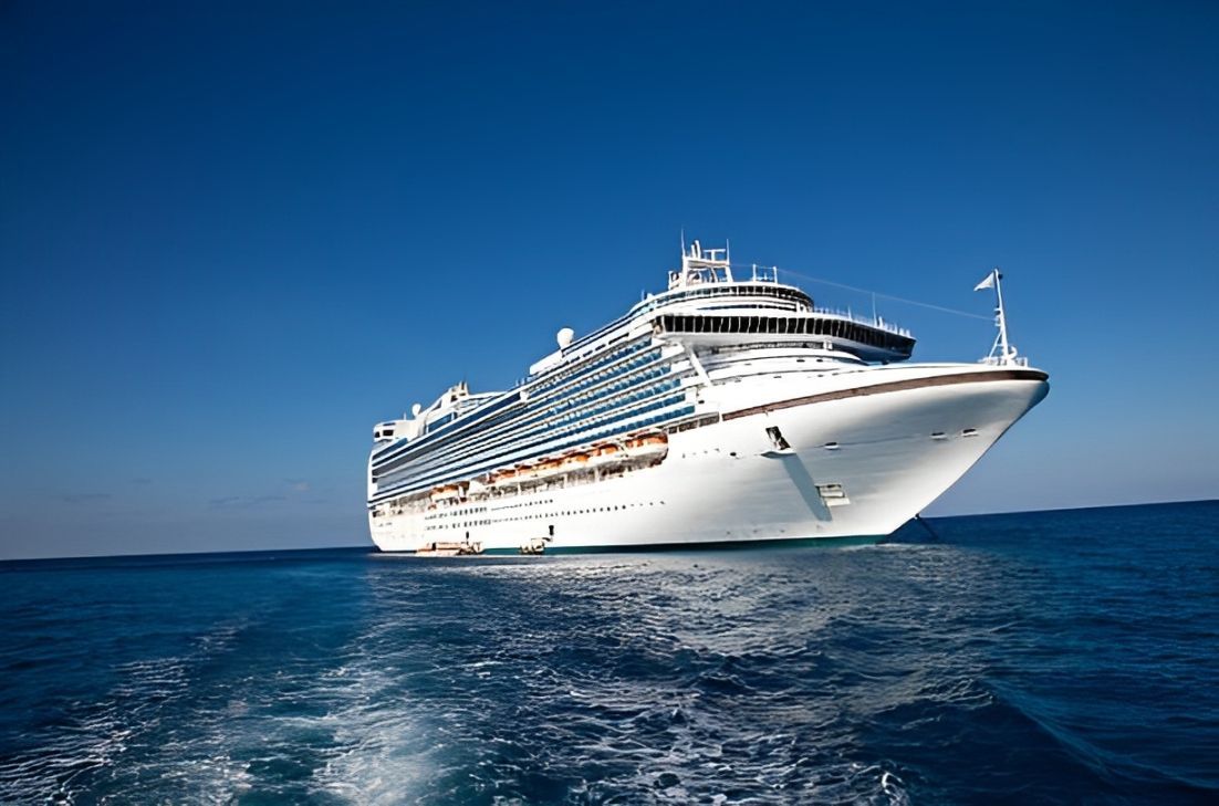 A large cruise ship is floating on top of a large body of water.
