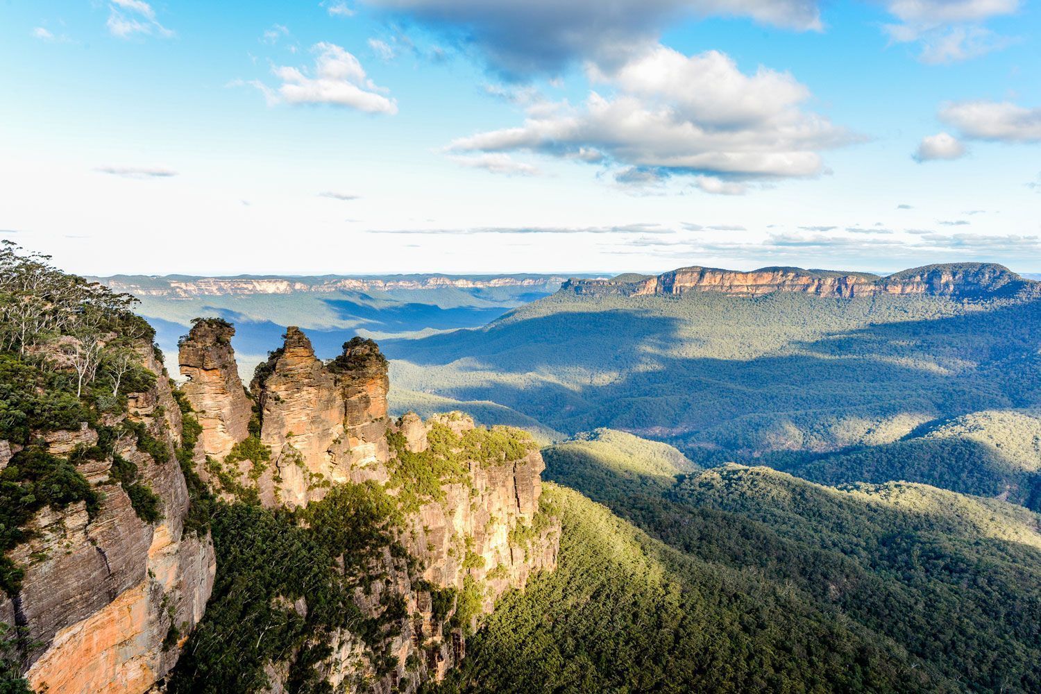 A view of a mountain range with trees and rocks