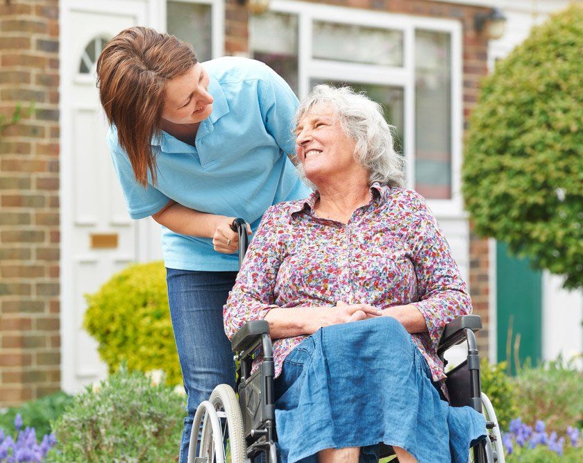 Carer With Senior Woman In Wheelchair — iCan Support Services Kawana QLD