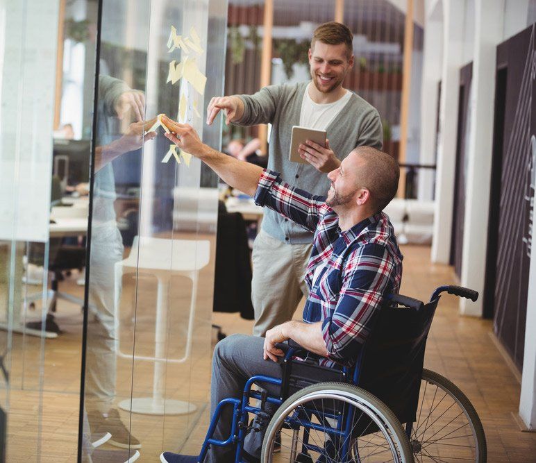 Disabled Man Sticking Adhesive Notes On Glass Window — iCan Support Services Kawana QLD
