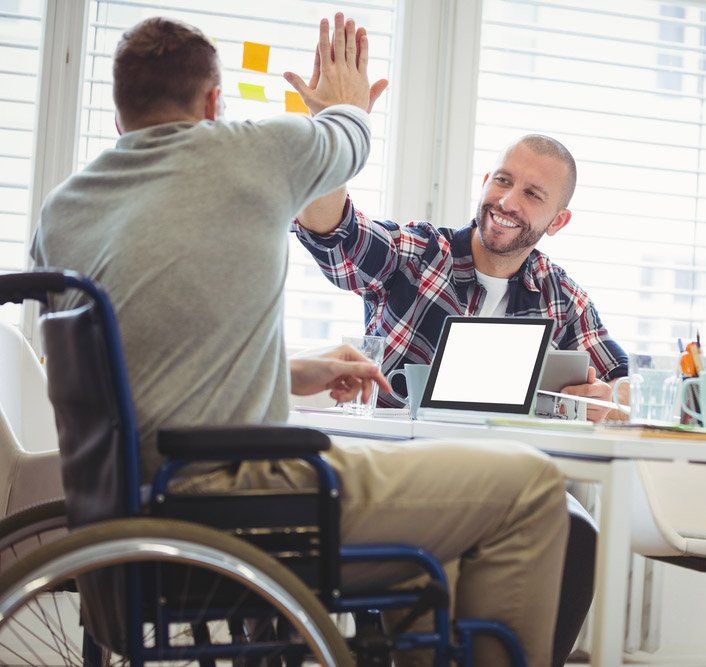 Men With Disabilities Giving High Five in creative office — iCan Support Services Kawana QLD