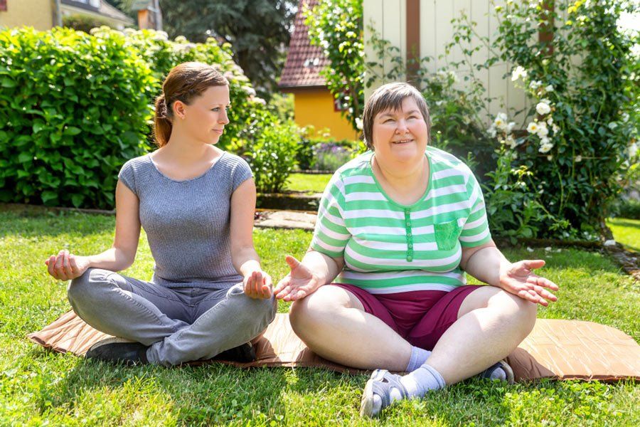 Women Coach Doing Some Yoga With The Women Mentally Disabled — iCan Support Services Kawana QLD